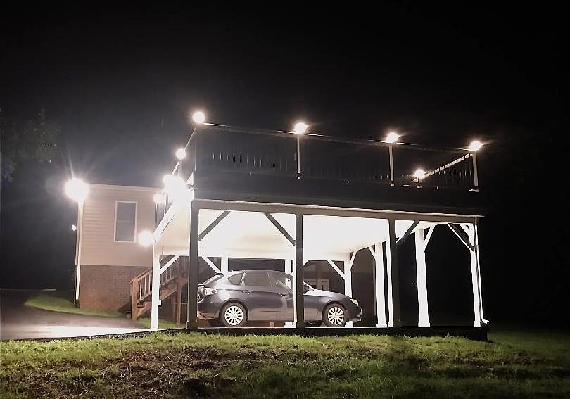 Deck and Carport Build lit up at night