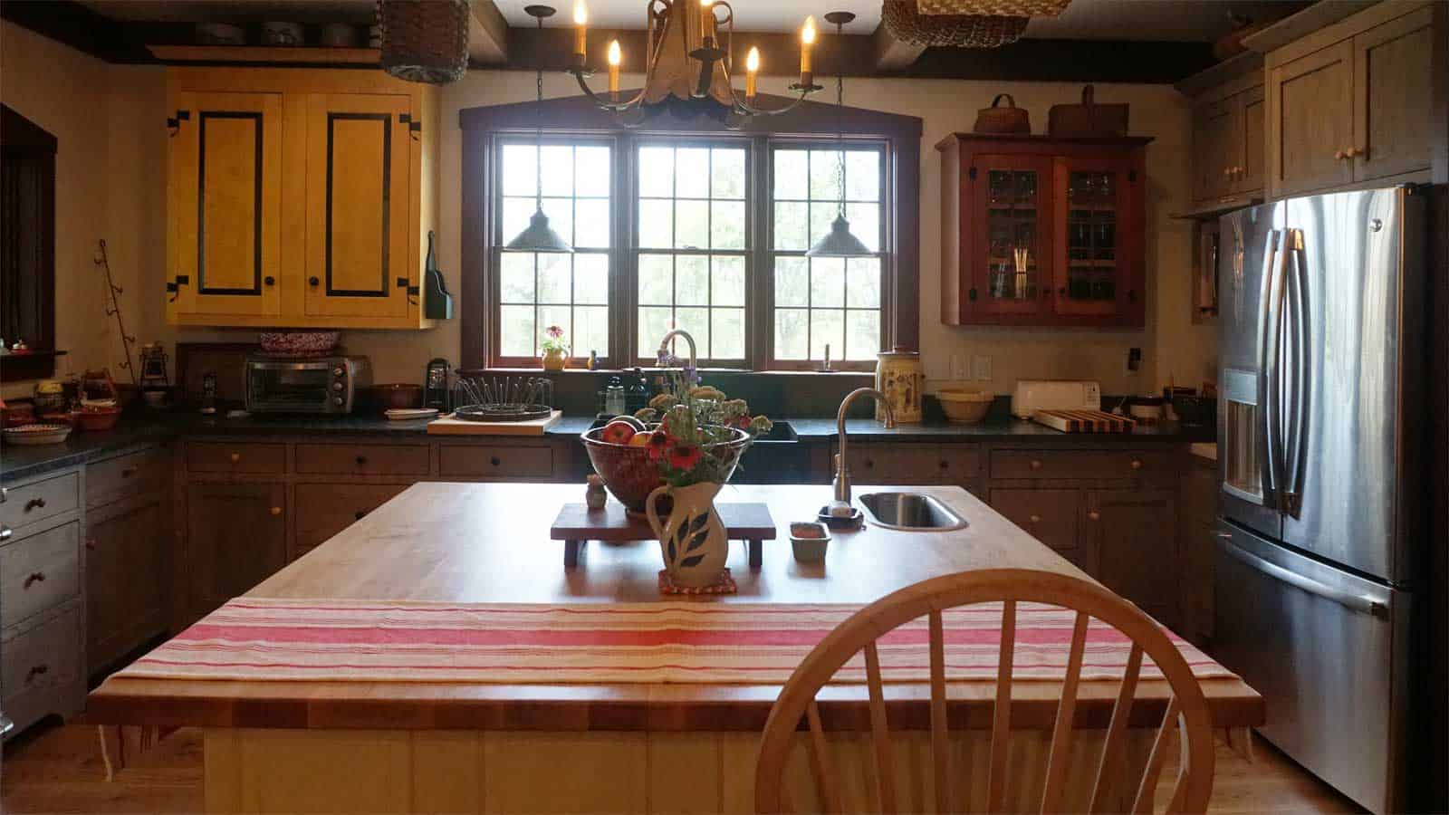Early American inspired Appomattox kitchen with custom antique modeled cabinets and large center island