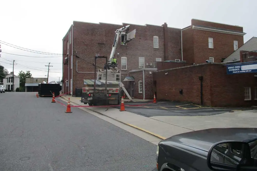Outside view during construction loading materials to the third floor offices